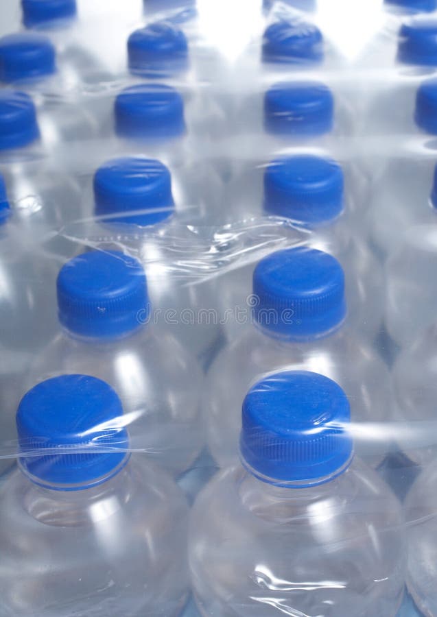 Rows of bottled water bottles in plastic wrap. Rows of bottled water bottles in plastic wrap