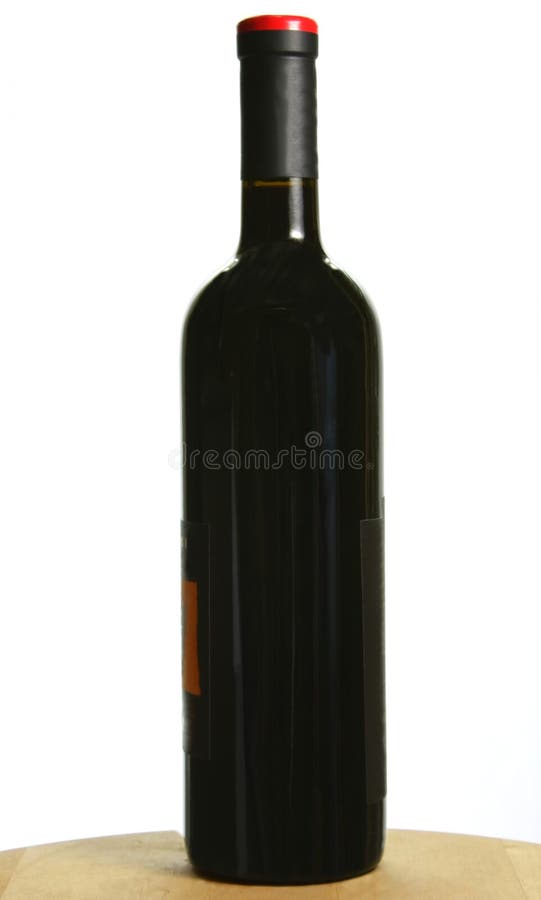 Single bottle of dark red wine on oak table, isolated. Single bottle of dark red wine on oak table, isolated