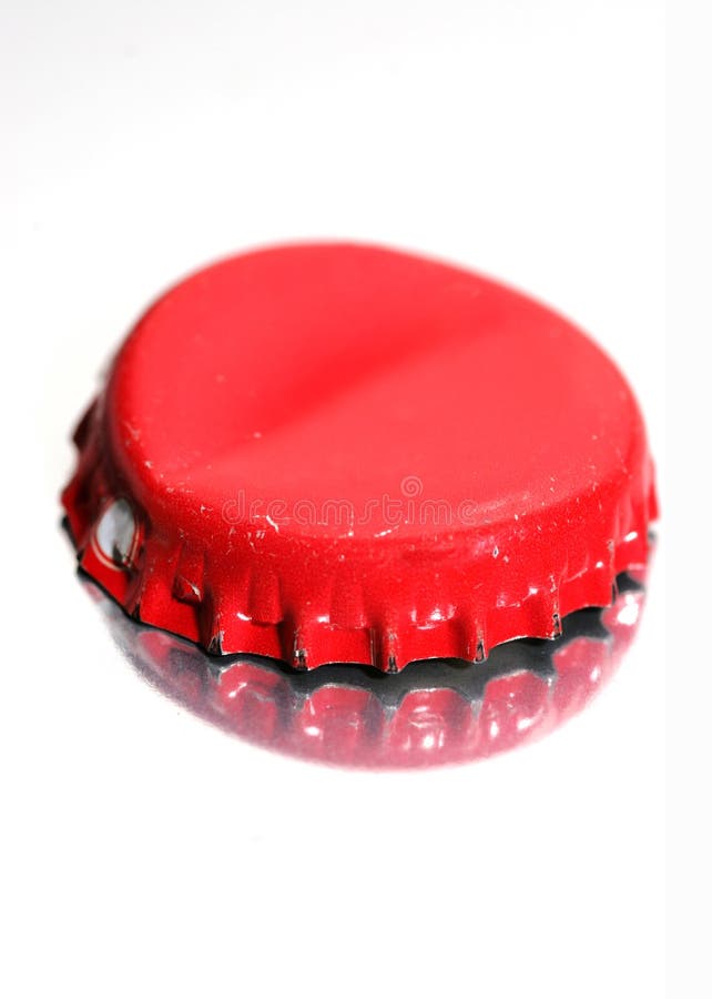 Bottle cap lying on a reflective white background. Bottle cap lying on a reflective white background