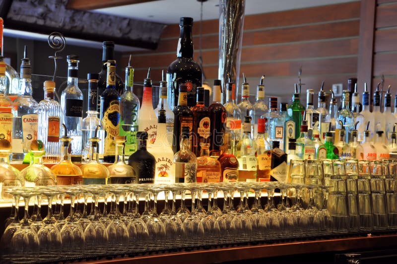 Ambient lighting reflecting of a bar with bottles of spirits and wine on shelve. Ambient lighting reflecting of a bar with bottles of spirits and wine on shelve