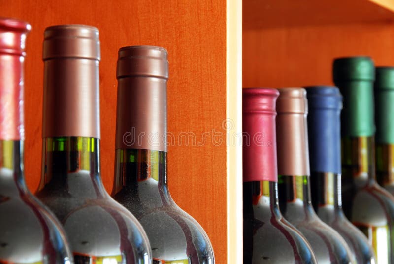 Various dark red wine bottles row on shelf. Various dark red wine bottles row on shelf