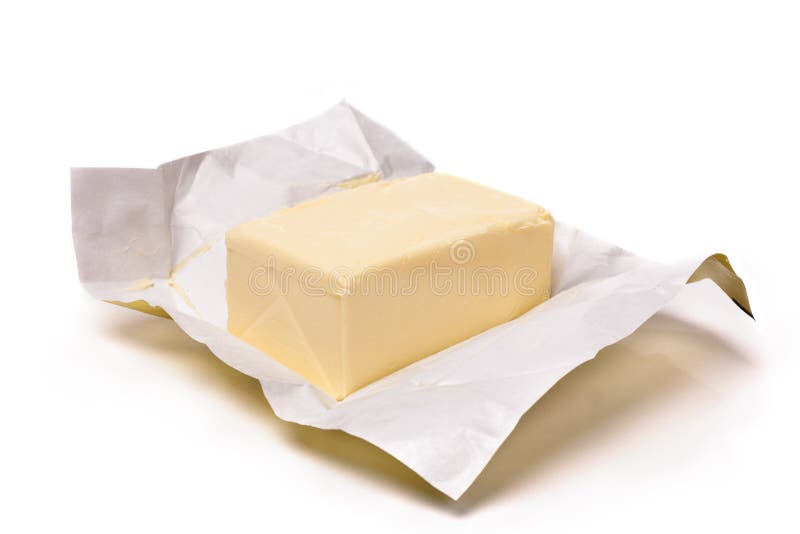 Piece of butter in paper on a white background. Shallow focus