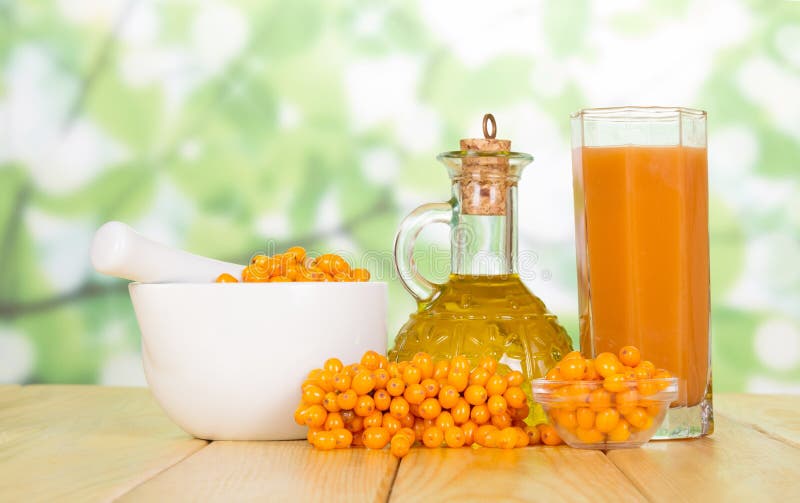 Butter, juice, and fresh sea buckthorn on the table stock images Butter, juice, and fresh sea buckthorn on the table stock images