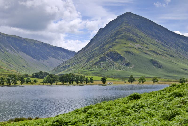 The Western end of Buttermere in the English Lake District with Fleetwith Pike rising beyond. The Western end of Buttermere in the English Lake District with Fleetwith Pike rising beyond