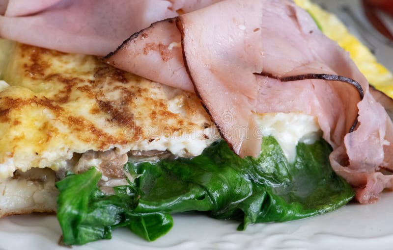Buttery omelette with ham and spinach stock photos Buttery omelette with ham and spinach stock photos