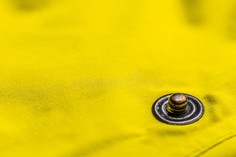 Close up of button clasp on yellow jacket. Button clasp stock images, royalty-free photos and pictures