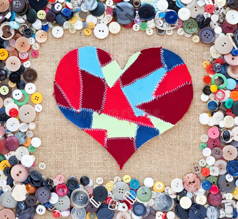 Fabric scraps heart on texture background. Valentine's Day. Buttons frame. Fabric scraps heart on texture background. Valentine's Day. Buttons frame