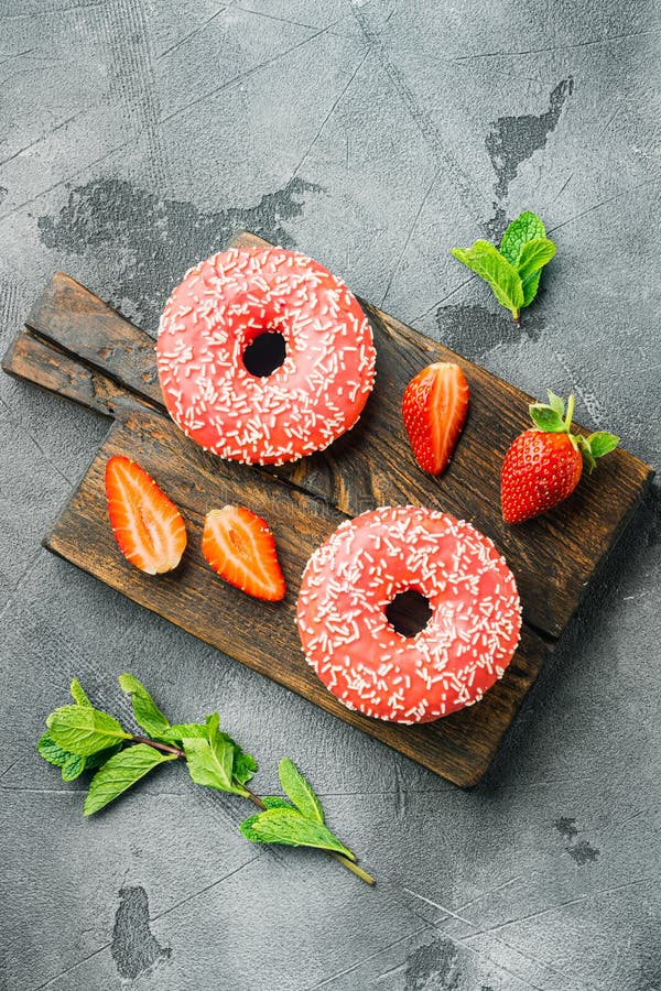 Strawberry  Donuts with berrie, on gray background, top view flat lay. Strawberry  Donuts with berrie, on gray background, top view flat lay