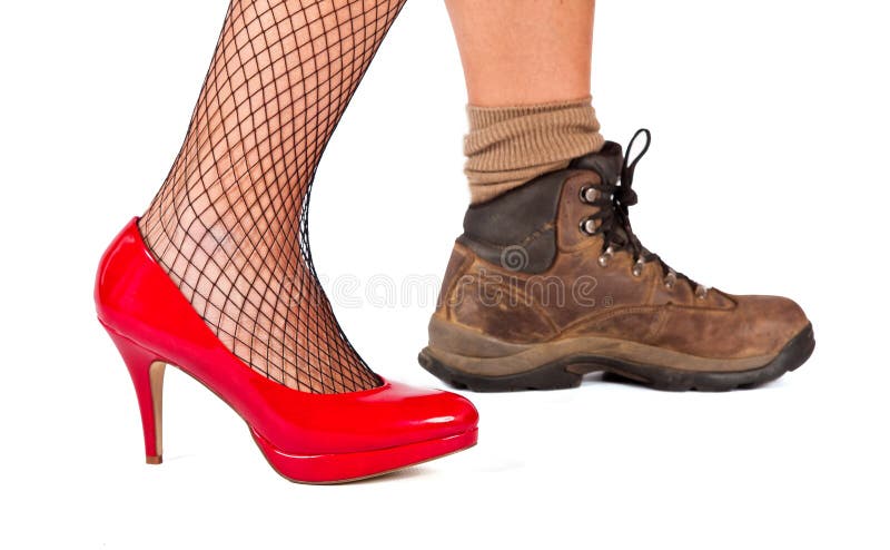 Red high hill shoe and brown walking boots on a white background. Red high hill shoe and brown walking boots on a white background