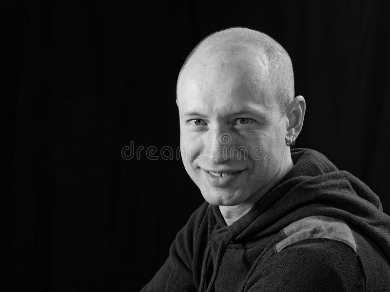 Portrait Of A Bald Cheerful Man In Profile On A Black Background Stock