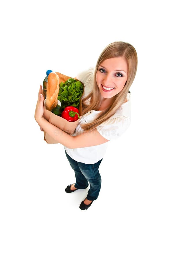 Woman carrying bag of groceries isolated on white. Woman carrying bag of groceries isolated on white