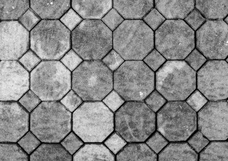 Top View of Monotone Grunge Gray Brick Stone on The Ground for Street Road. Sidewalk, Driveway, Pavers, Pavement in Vintage Design Flooring Hexagon Pattern Texture Background. Top View of Monotone Grunge Gray Brick Stone on The Ground for Street Road. Sidewalk, Driveway, Pavers, Pavement in Vintage Design Flooring Hexagon Pattern Texture Background