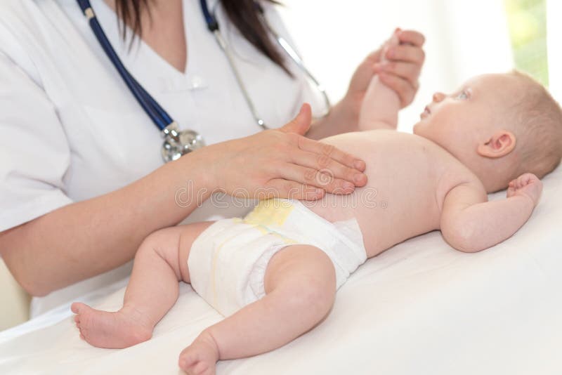 Bébé de examen de pédiatre photo stock Bébé de examen de pédiatre photo stock
