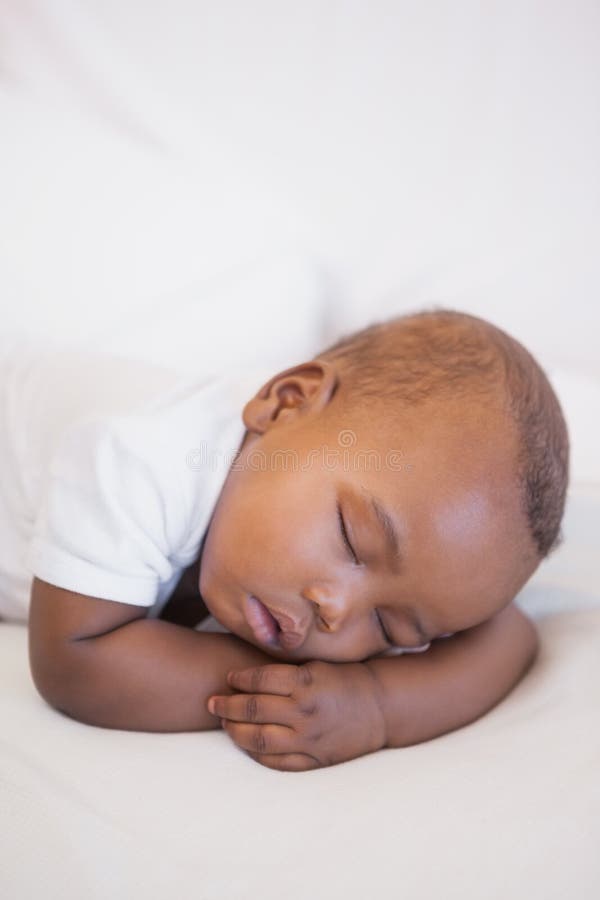 Bébé garçon dormant paisiblement sur le divan images stock Bébé garçon dormant paisiblement sur le divan images stock