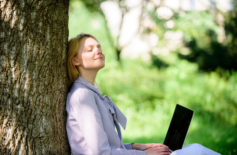 Natural environment office. Work outdoors benefits. Woman with laptop work outdoors lean tree. Minute for relax. Education technology and internet concept. Girl work with laptop in park sit on grass. Natural environment office. Work outdoors benefits. Woman with laptop work outdoors lean tree. Minute for relax. Education technology and internet concept. Girl work with laptop in park sit on grass.