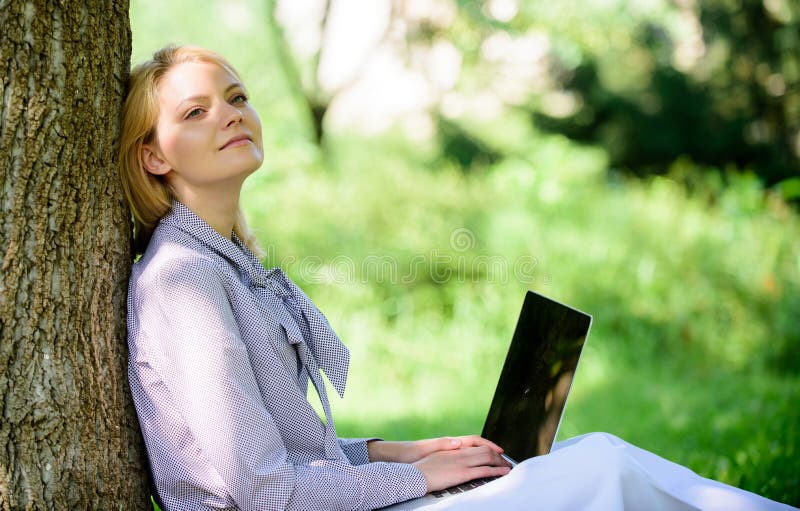 Natural environment office. Work outdoors benefits. Woman with laptop work outdoors lean tree. Minute for relax. Girl work with laptop in park sit on grass. Education technology and internet concept. Natural environment office. Work outdoors benefits. Woman with laptop work outdoors lean tree. Minute for relax. Girl work with laptop in park sit on grass. Education technology and internet concept.