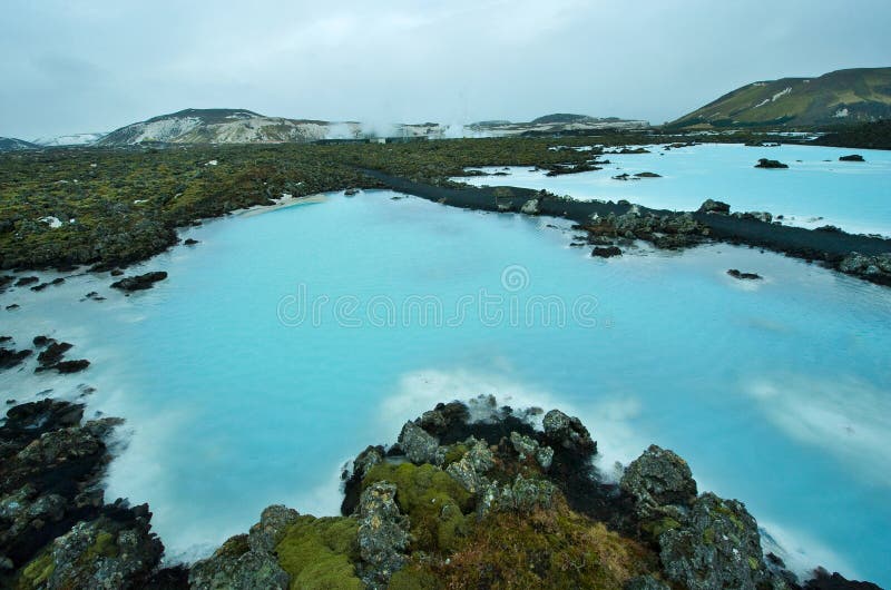 The blue water between the lava stones covered with moss just outside the Blue Lagoon resort of Iceland. The blue water between the lava stones covered with moss just outside the Blue Lagoon resort of Iceland