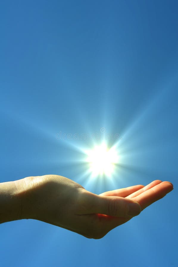 Hand sun and blue sky with copyspace showing freedom or solar power concept. Hand sun and blue sky with copyspace showing freedom or solar power concept