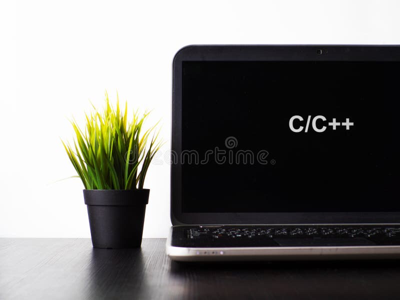 C plus programming language. Programming training, the concept of computer courses. Laptop on the table with C plus written on the screen