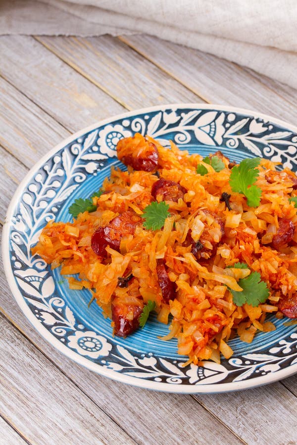 Cabbage with Sausages, Carrot, Onion and Tomato Sauce. Stock Photo