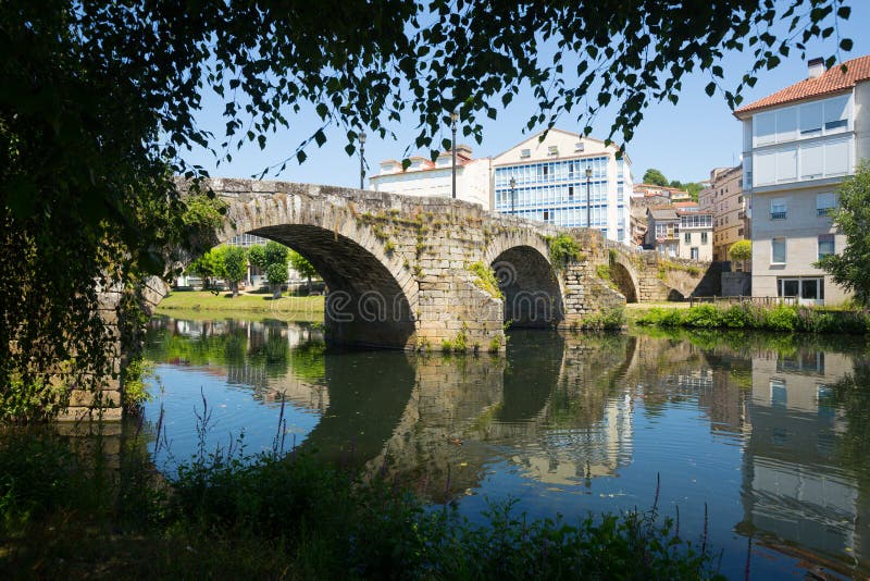 Cabe river and old bridge at Monforte de Lemos in sunny day. Galicia