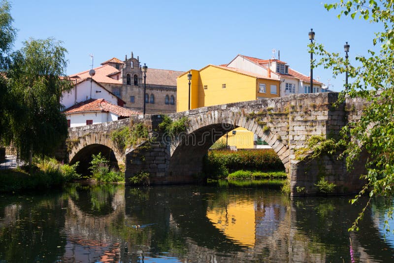 Cabe river and old bridge at Monforte de Lemos in sunny summer day. Galicia, Spain