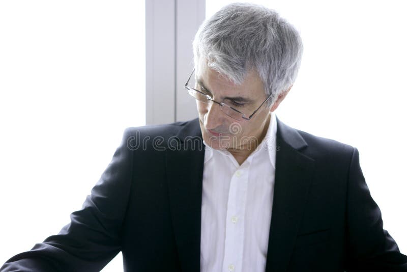 Cabelo cinzento sênior do homem de negócios que olha para baixo imagens de stock royalty free Cabelo cinzento sênior do homem de negócios que olha para baixo imagens de stock royalty free
