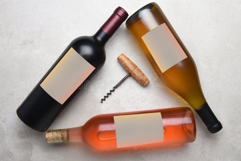 Cabernet, Rose, Chardonnay: Overhead view of a group of three different bottles with blank labels arranged in a triangle with a stock image