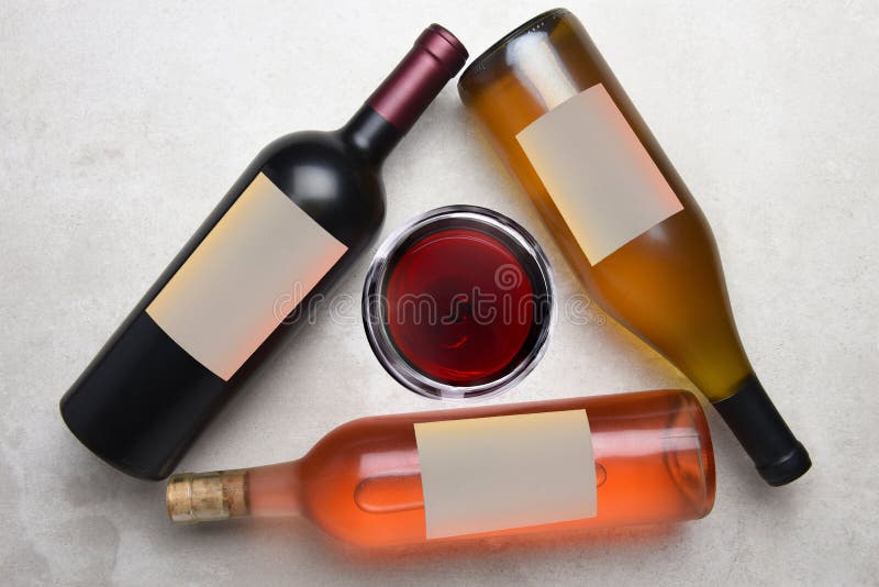 Cabernet, Rose, Chardonnay: Overhead view of a group of three different bottles with blank labels arranged in a triangle with a royalty free stock image