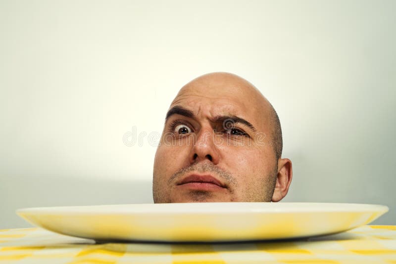 Bold human head with open eyes on a dinner plate. Bold human head with open eyes on a dinner plate
