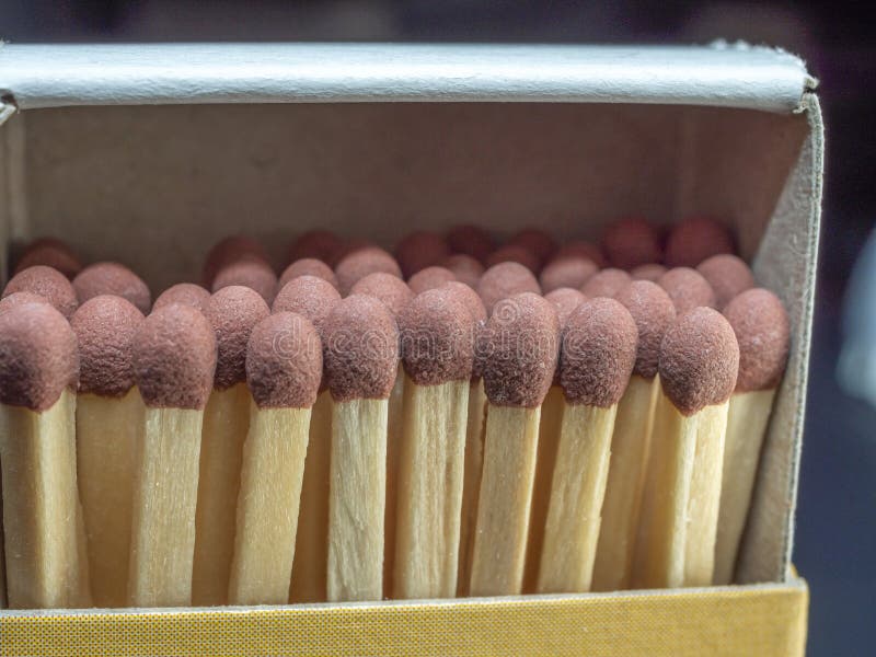 Heads of wooden matches in an open matchbox. Close-up. Heads of wooden matches in an open matchbox. Close-up