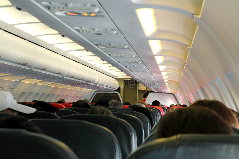 Commercial airplane cabin with passengers. Commercial airplane cabin with passengers