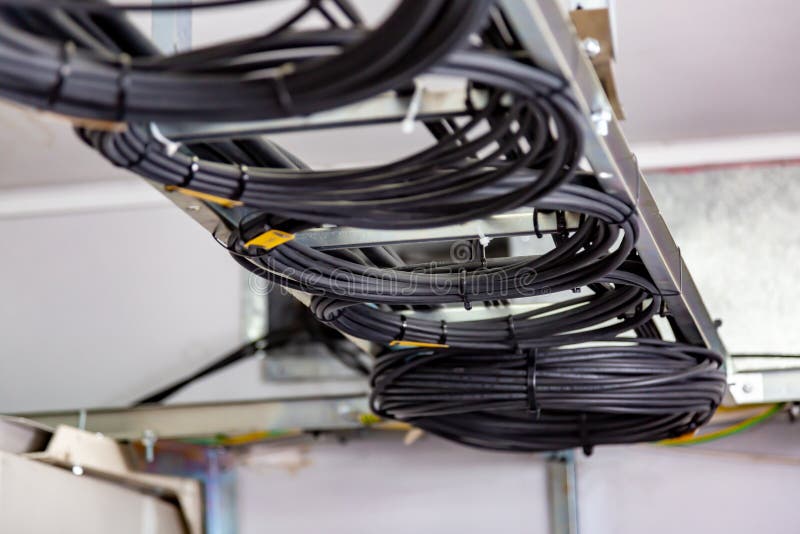 Cable Management. Working Wires, Cables Wound into a Coil, a Circle. Two Rings of Coiled Wires