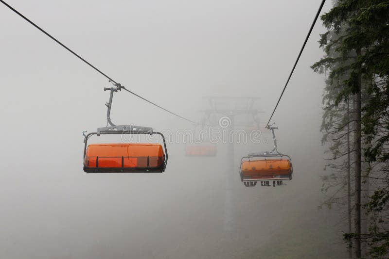 Cableway in foggy mountain