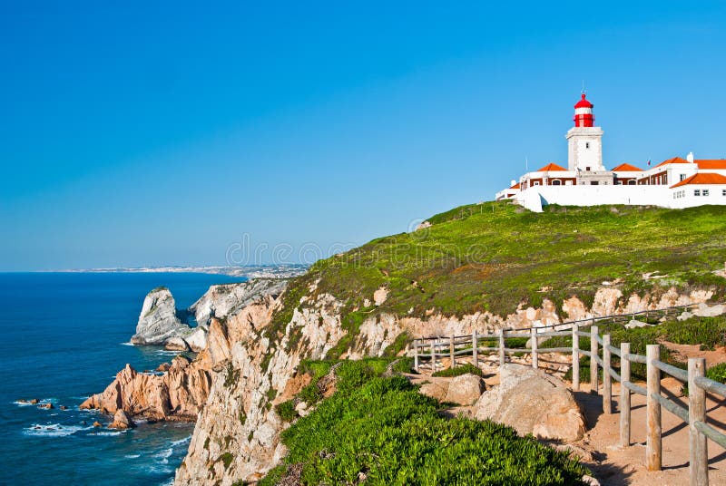 Cabo da Roca (Cape Roca) is a cape which forms the westernmost point of both mainland Portugal and mainland Europe. The cape is in the Portuguese municipality of Sintra, west of Lisbon district, and also forms the westernmost extent of the Serra de Sintra
