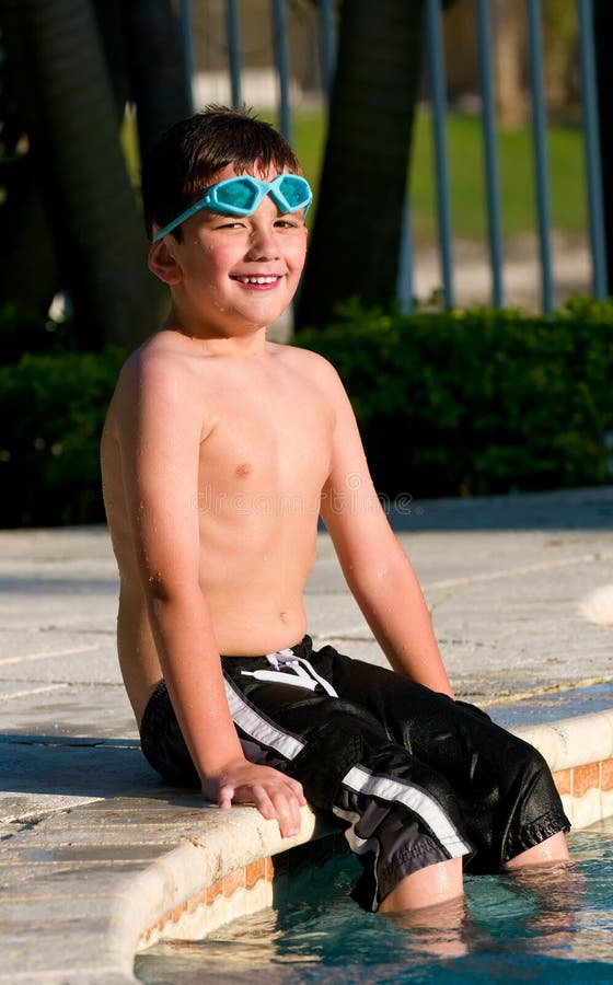 Portrait of a kid seating in a swimming pool. Portrait of a kid seating in a swimming pool.