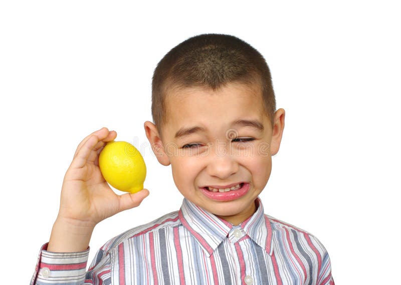 Six-year-old boy holding a lemon and making a sour face, isolated on white background. Six-year-old boy holding a lemon and making a sour face, isolated on white background