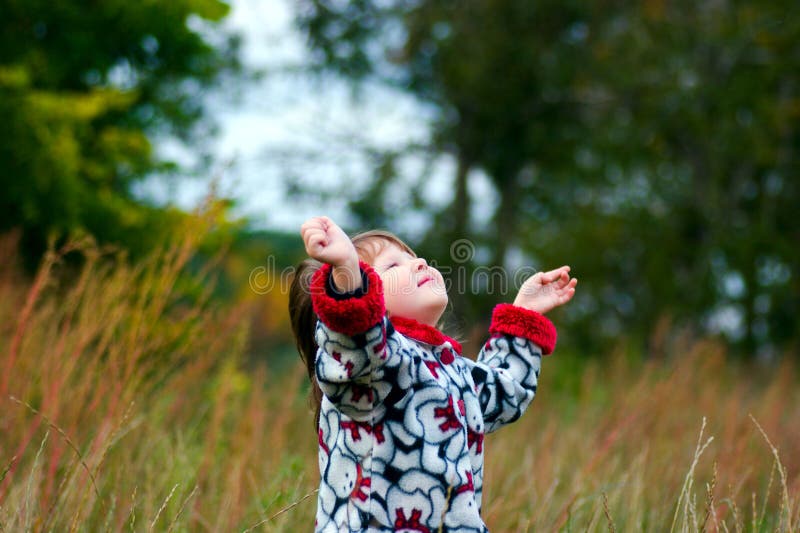 Kid looking up to the sky in the autumn meadow. Kid looking up to the sky in the autumn meadow