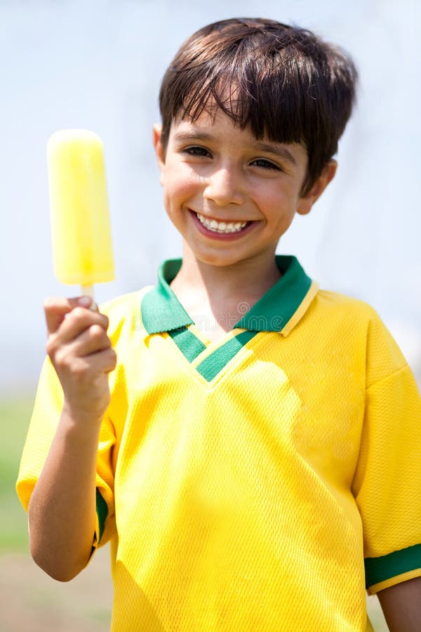 Smiling kid holding an icecream and looking at camera. Smiling kid holding an icecream and looking at camera