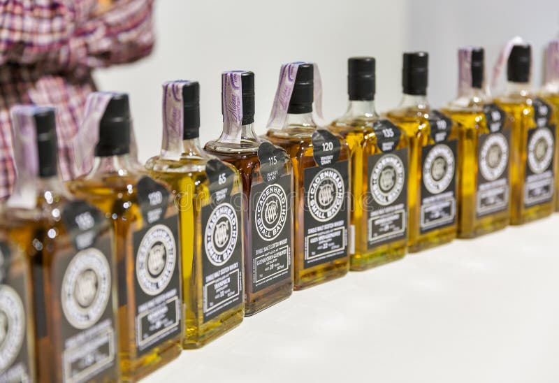 Cadebhead bottles at Whisky Dram Festival in Kiev, Uktaine. Independent bottler Cadenhead Small Batch Glenrothes Glenlivet whisky bottles in a row at booth of stock photo