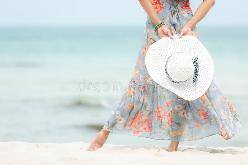 Cadeira de plataforma na praia em Brigghton Fim acima da mão que guarda o chapéu branco grande Viagens vestindo do verão da forma fotografia de stock Cadeira de plataforma na praia em Brigghton Fim acima da mão que guarda o chapéu branco grande Viagens vestindo do verão da forma fotografia de stock