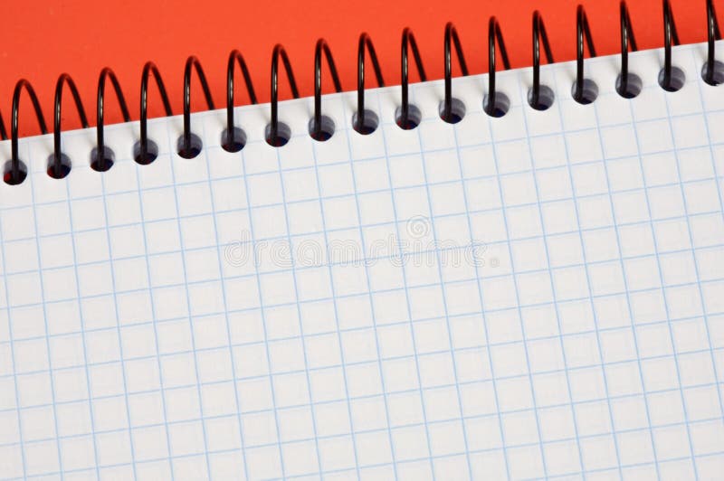 Notebook over a red background - write your text -. Notebook over a red background - write your text -