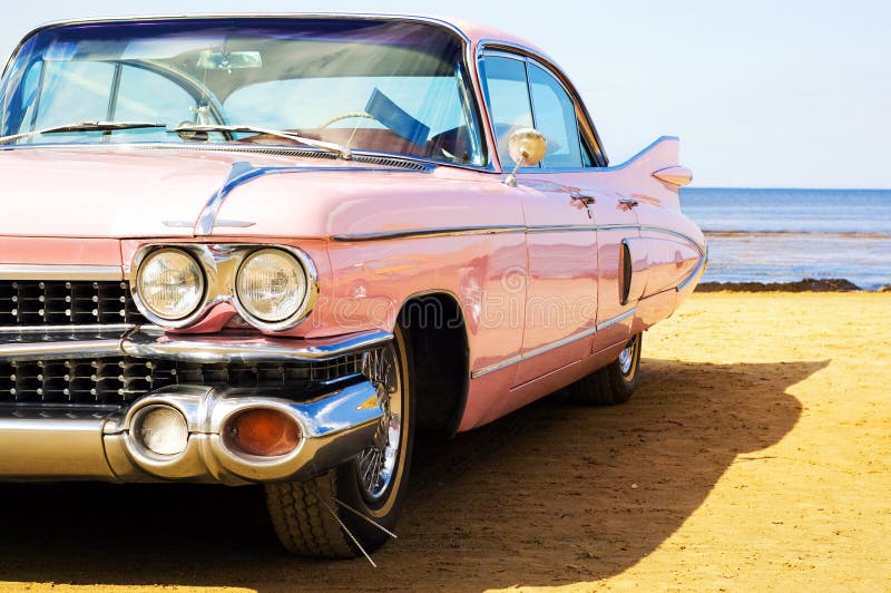 Classic pink Cadillac at beach on sunny day. Classic pink Cadillac at beach on sunny day