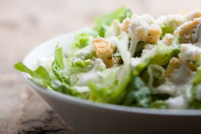 Caesar salad. Ceasar salad with lots of dressing and parmesan royalty free stock photography