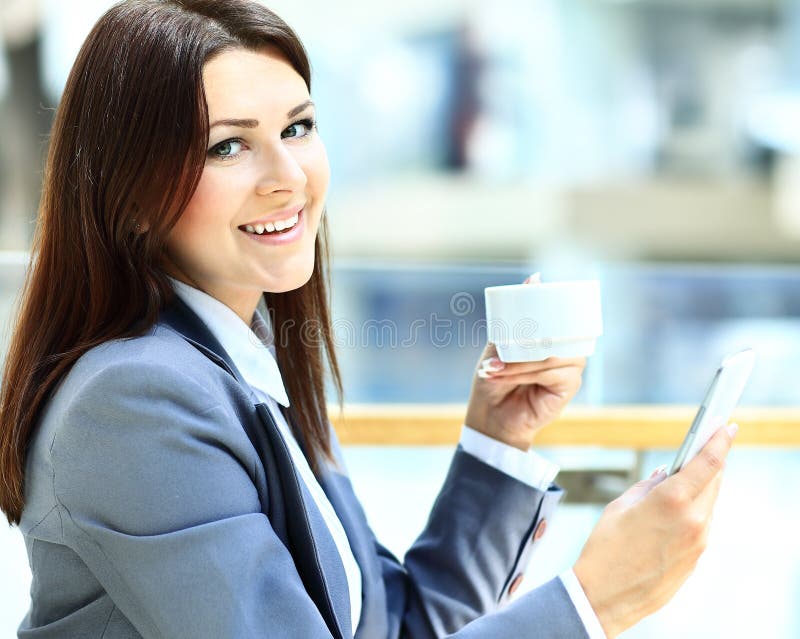 Cafe city lifestyle woman on phone drinking coffee texting text