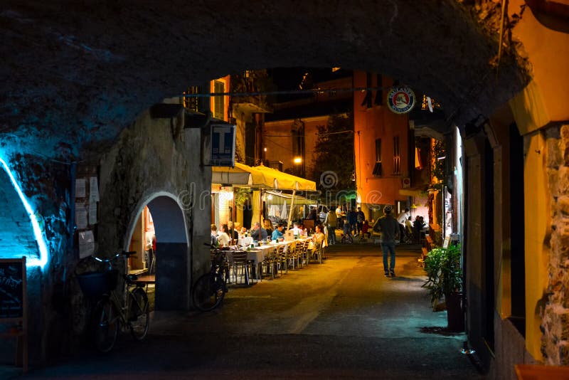 A cafe filled with tourists at night in Monterosso al Mare, Cinque Terre, Italy. Late night in the village of Monterosso Al Mare, part of the Cinque Terre in stock photos A cafe filled with tourists at night in Monterosso al Mare, Cinque Terre, Italy. Late night in the village of Monterosso Al Mare, part of the Cinque Terre in stock photos