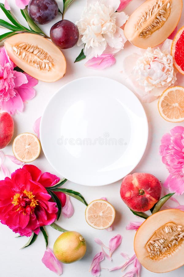 Cafe menu background with beautiful peonies flowers fruits and white plate, seasonal spring summer time concept, freshness, detox