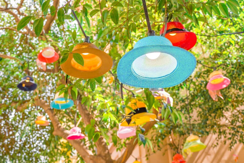 Cafe outside light decor closeup. Summer concept. Vacation, travel conceptual. New life for old hats, panamas