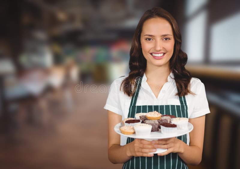 Cafe Owner Holding Cupcakes Against Blurry Cafe Stock Photo Image of