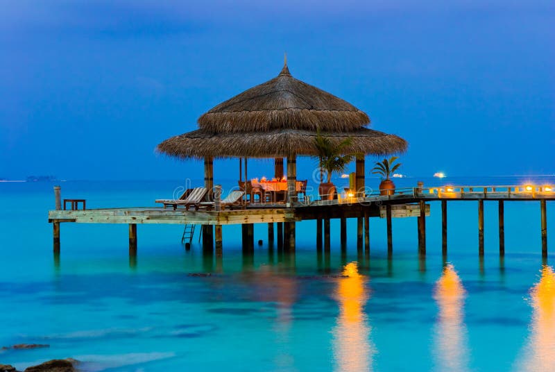 Water cafe at evening, lights, ocean and sky. Water cafe at evening, lights, ocean and sky